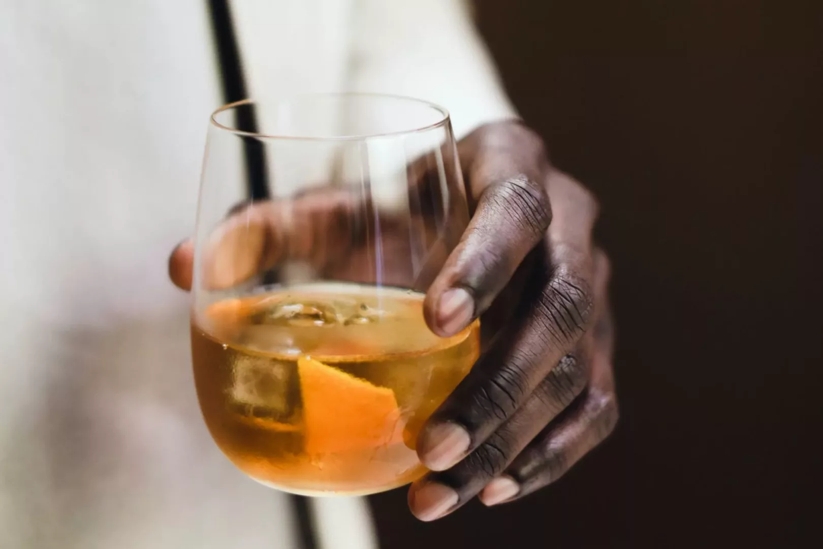 a person holding a cocktail glass