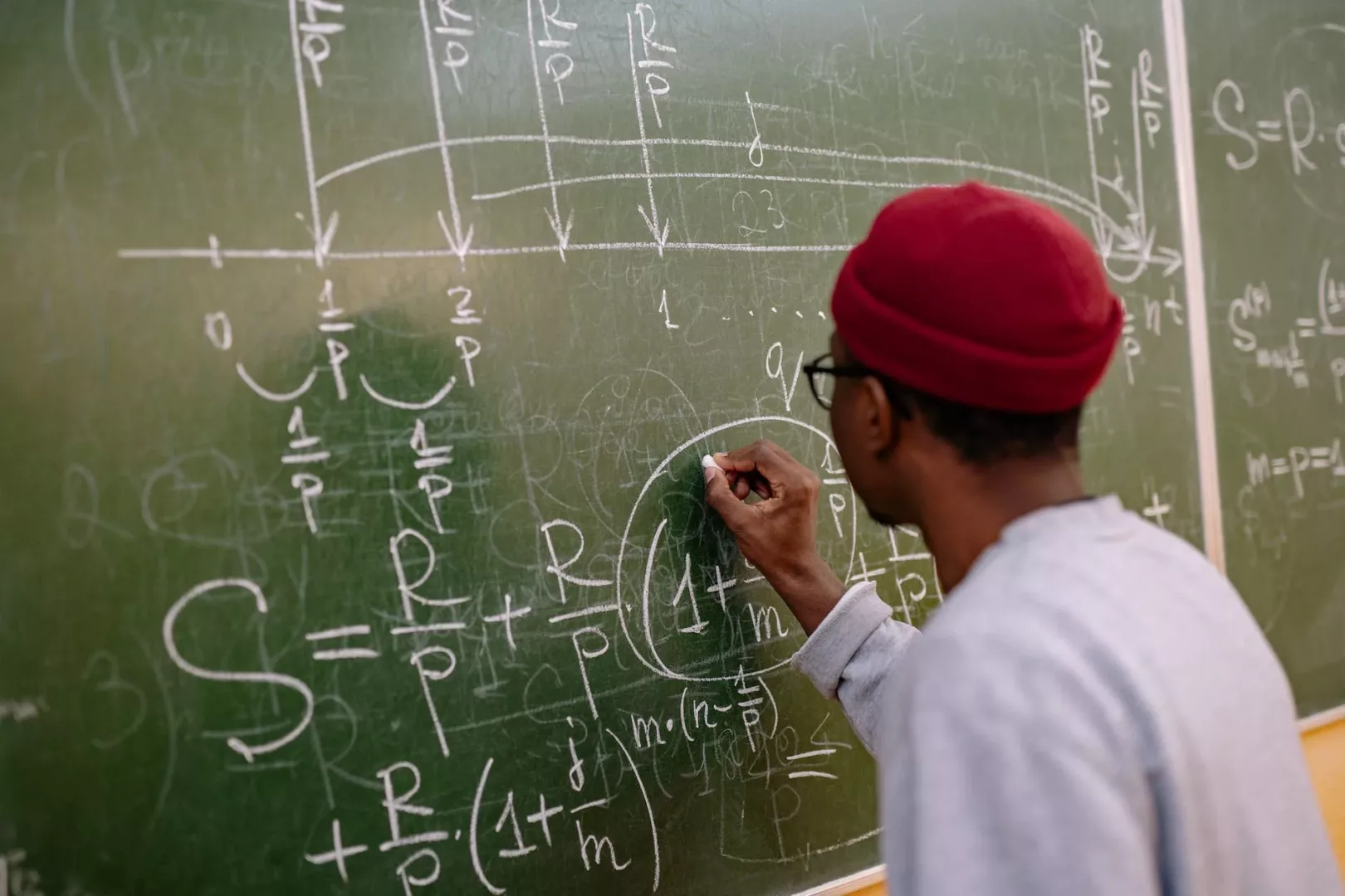 back view of a student answering a problem on the chalkboard