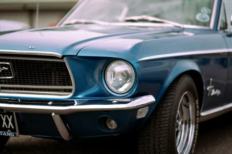 view of the front of a blue ford mustang fastback