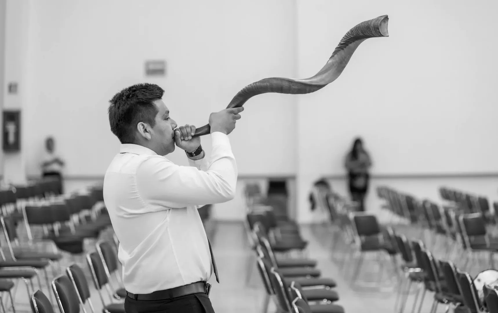 man playing on jewish instrument in black and white