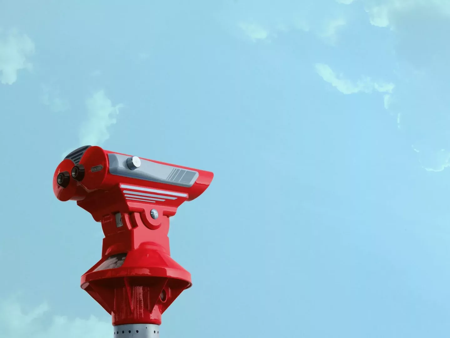 red theodolite under blue sky and white clouds