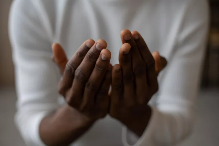 crop black man praying at home