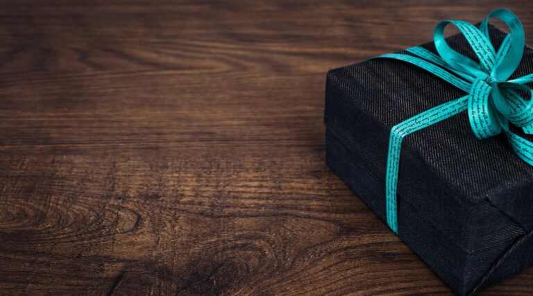 black gift box on wooden surface