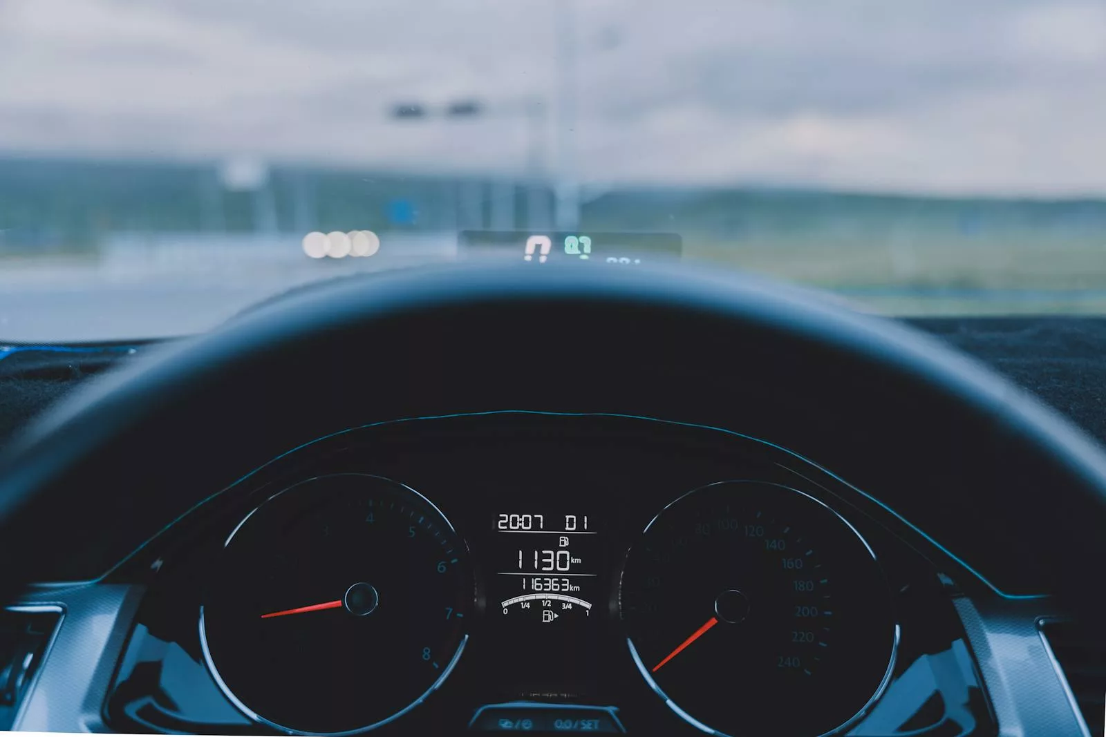 A dashboard with a speedometer and a steering wheel