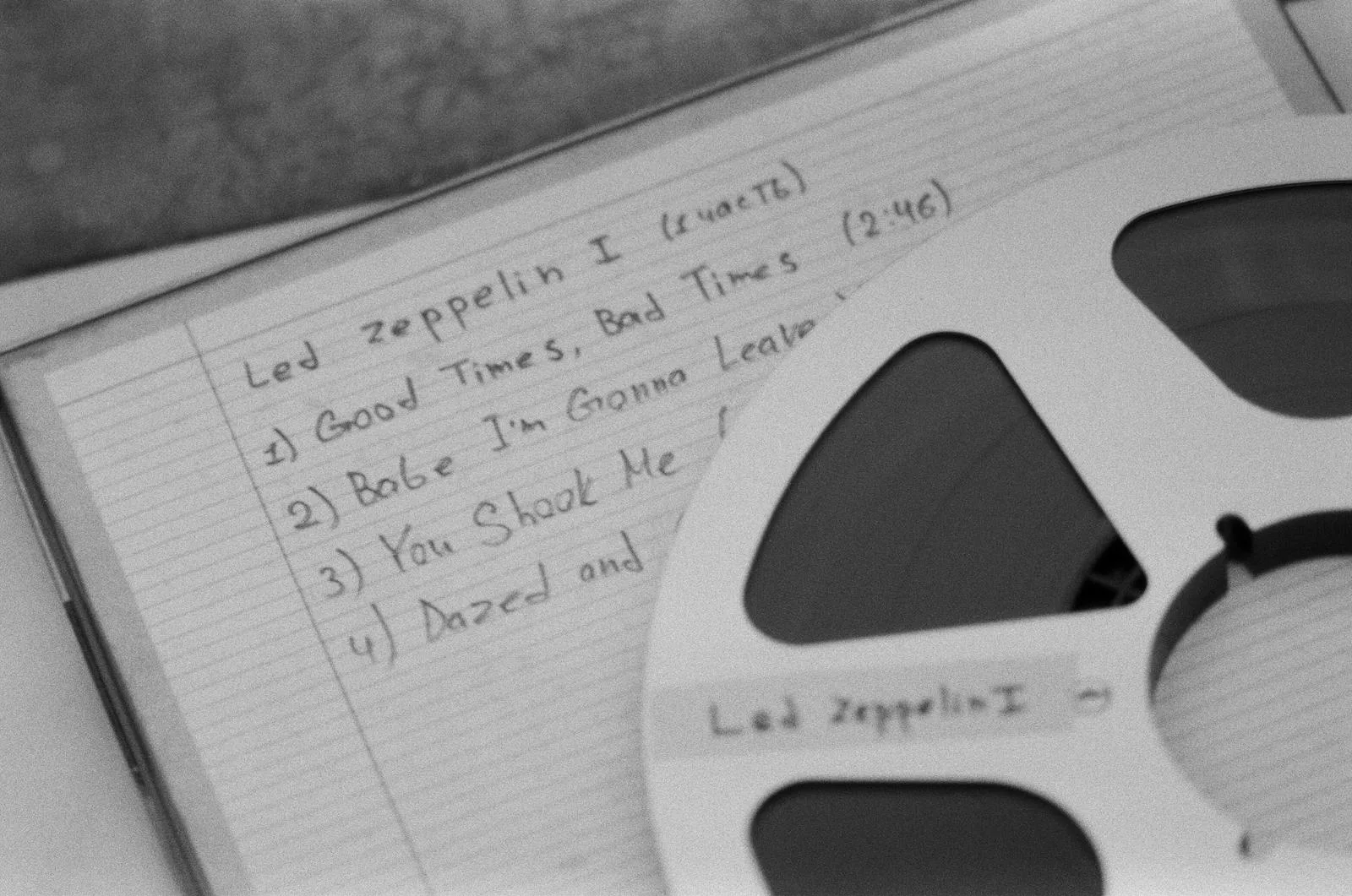 Close-up of a retro reel and handwritten music notes, evoking nostalgia.