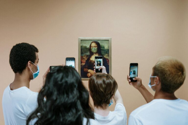 Group of masked visitors photographing a humorous Mona Lisa with a mask in a museum.