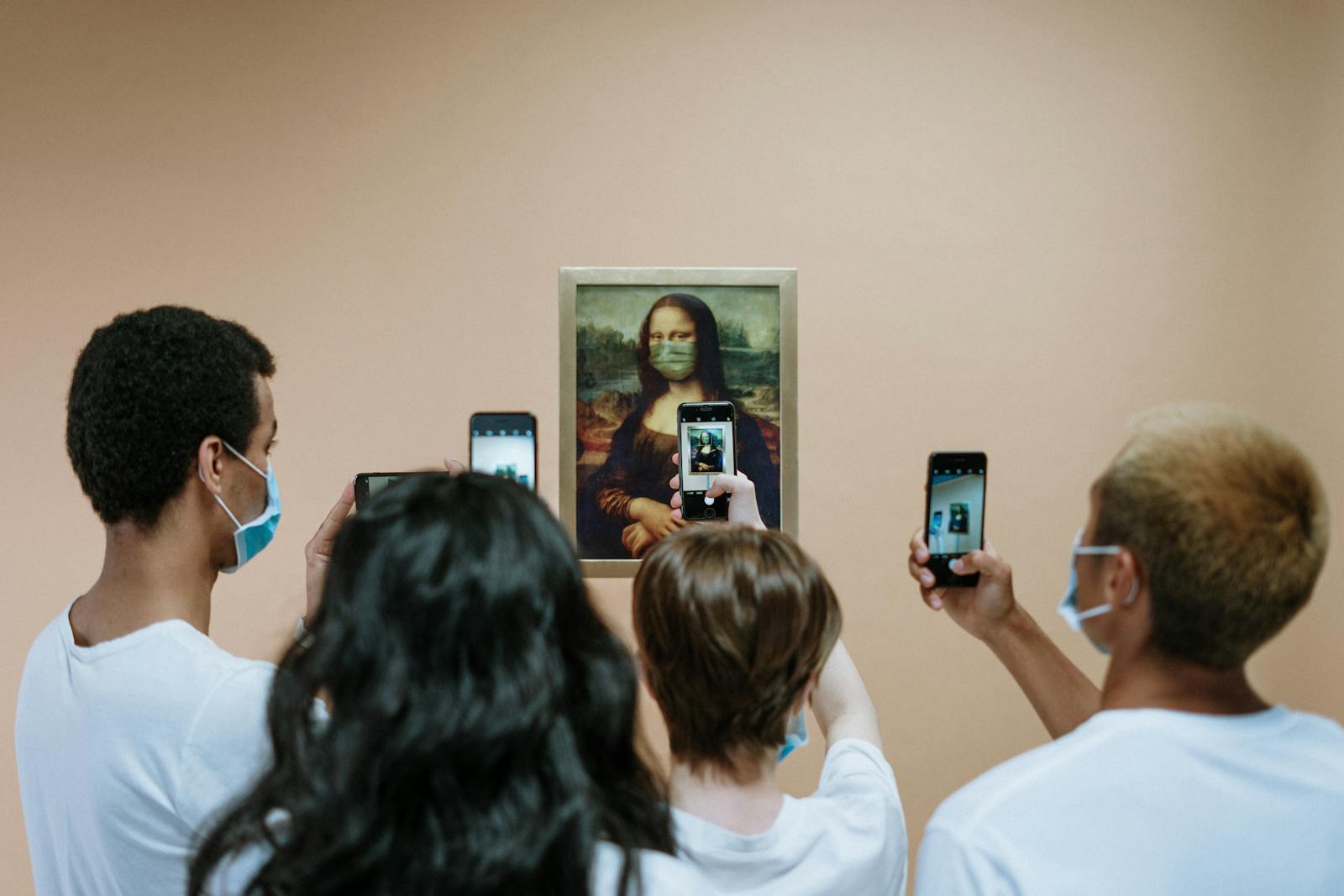 Group of masked visitors photographing a humorous Mona Lisa with a mask in a museum.