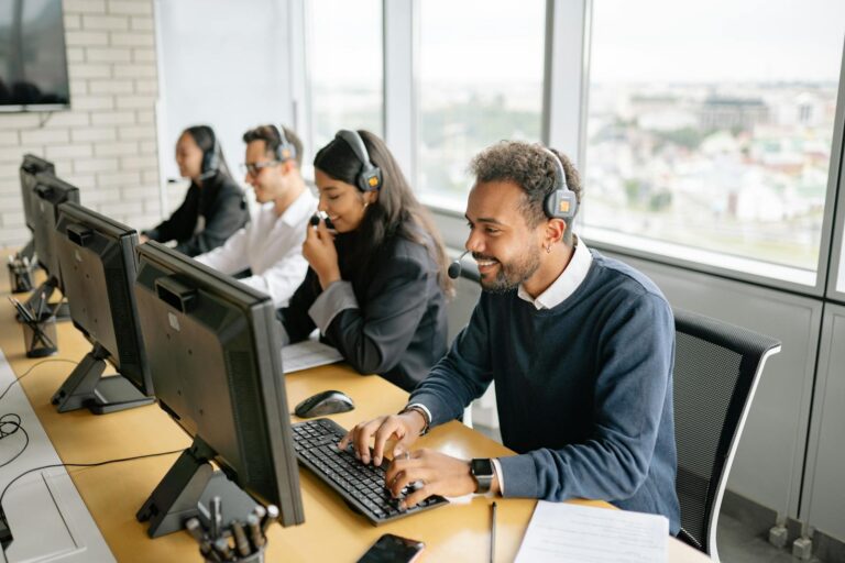 A diverse team of call center agents working together in an office setting.