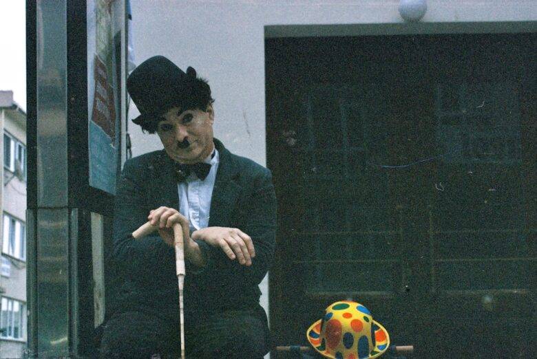 A street performer dressed as Charlie Chaplin poses outdoors in Istanbul.